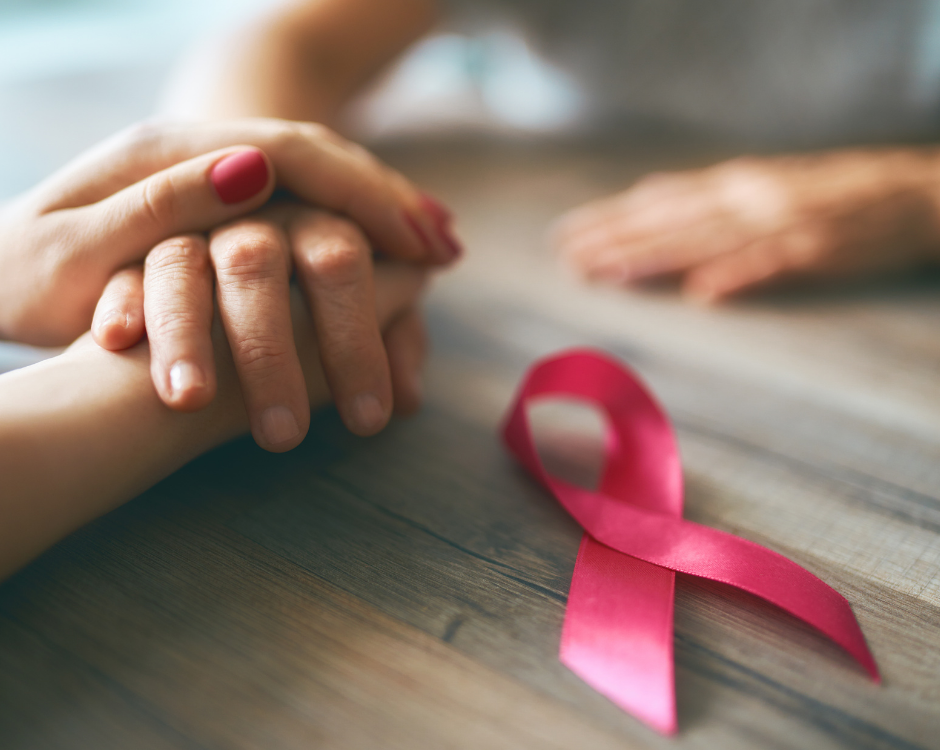 hands with pink ribbon